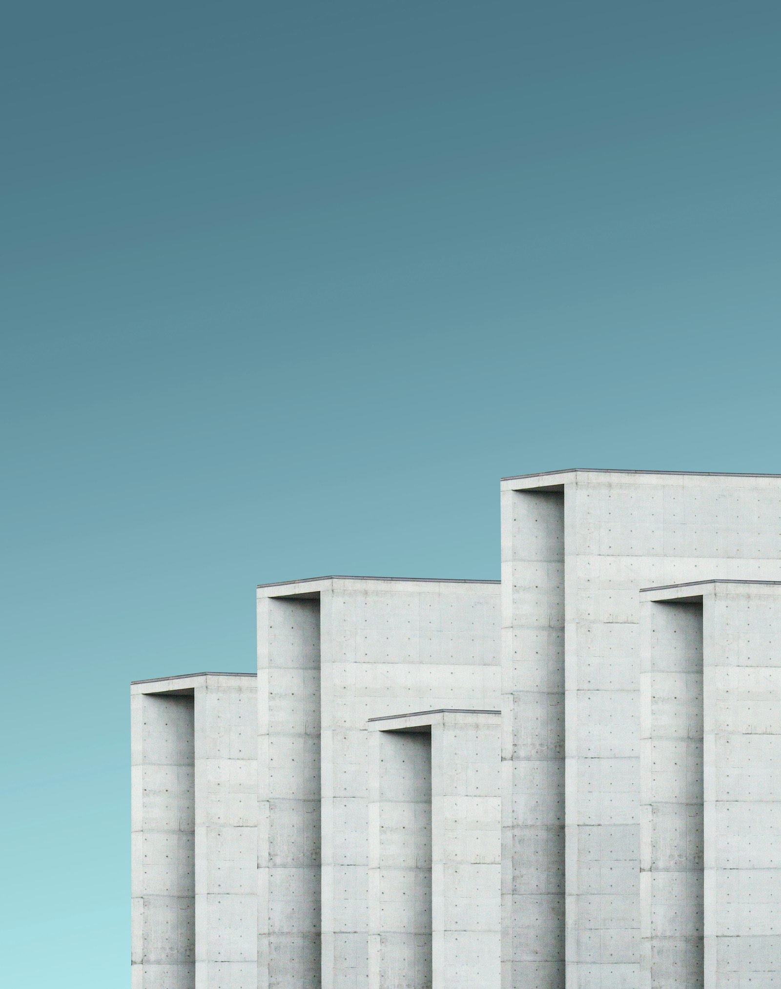 Grey concrete facade with a geometric structure