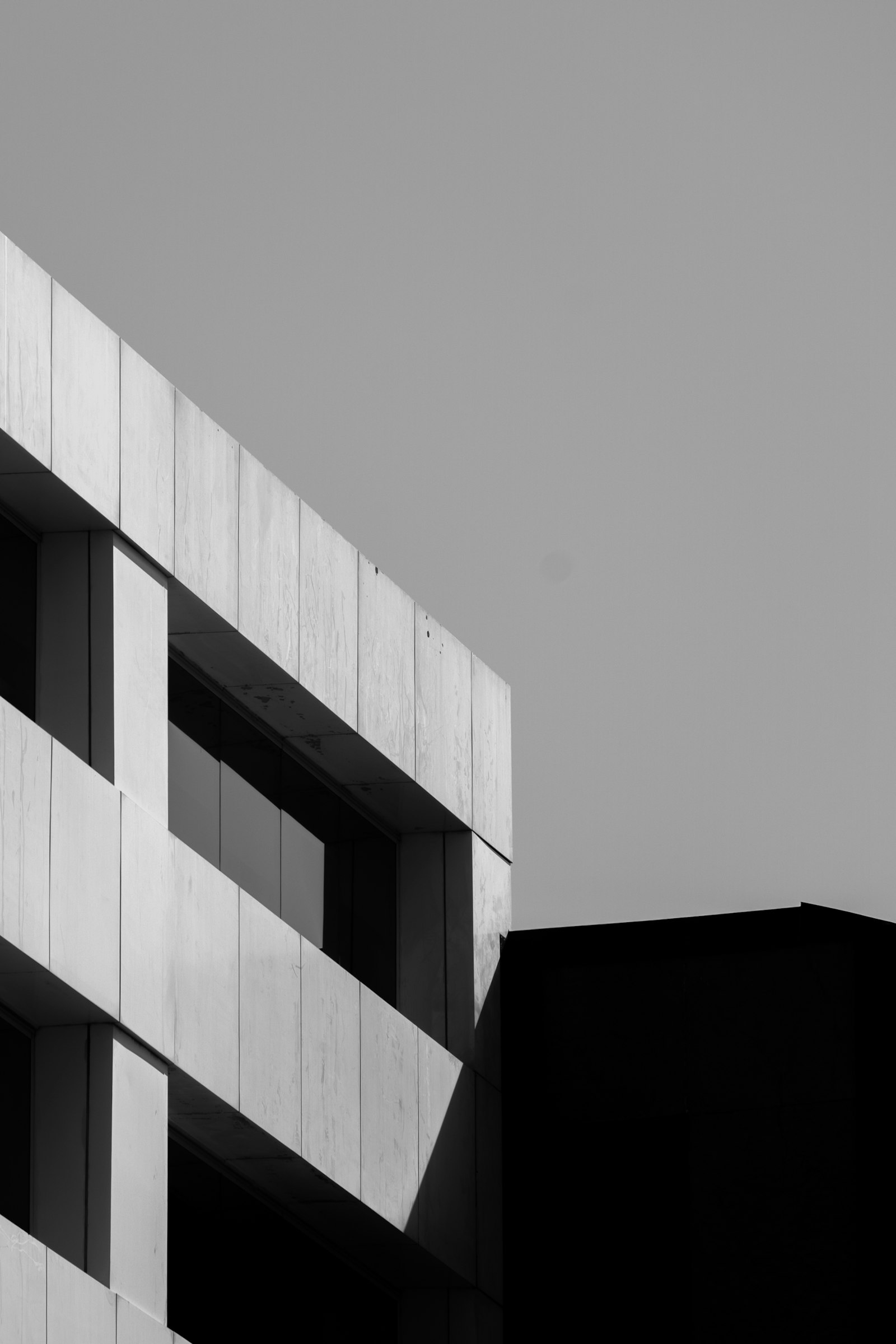 Black and white photograph of a building with light and shadow